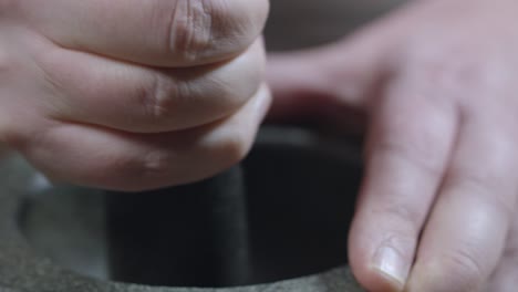 Closeup-video-of-chef-using-a-mortar-and-pestle-with-his-two-hands