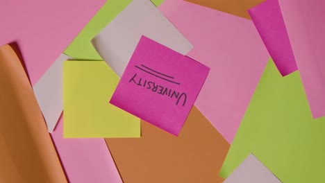 concepto educativo de notas adhesivas giratorias con universidad escrita en la nota superior