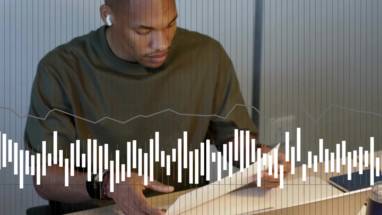 Business analyst sorting pink notes, using laptop and reviewing charts with waveform running below