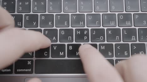 hands typing on a laptop keyboard