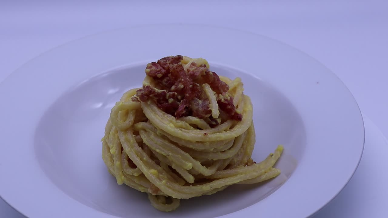 Classic Italian spaghetti alla carbonara on a white plate ready to be enjoyed for dinner
