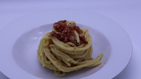 classic italian spaghetti alla carbonara on a white plate ready to be enjoyed for dinner
