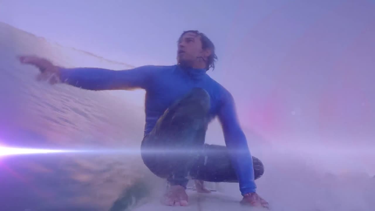animación de luces sobre un surfista caucásico surfeando en las olas