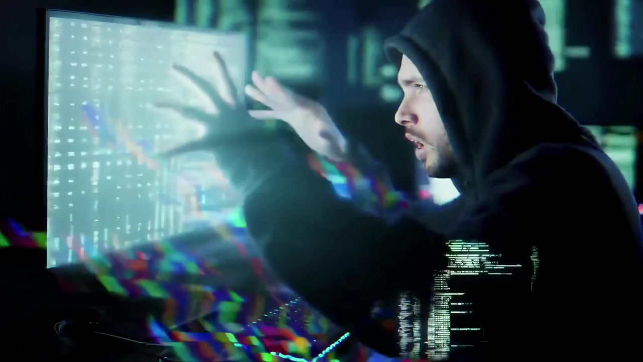 Hacker in Hoodie Typing Rapidly on Computer with Digital Glitch Effects