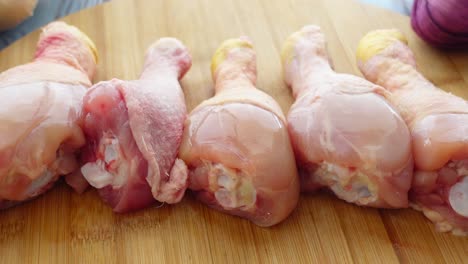 raw chicken legs on cutting board