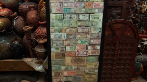 various banknotes displayed among traditional pottery