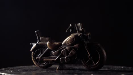 metal-bike-toy-turntable-lighter-dark-background-cruiser-bike