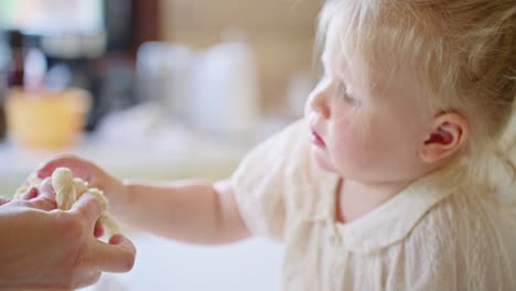 toddler playing with dough