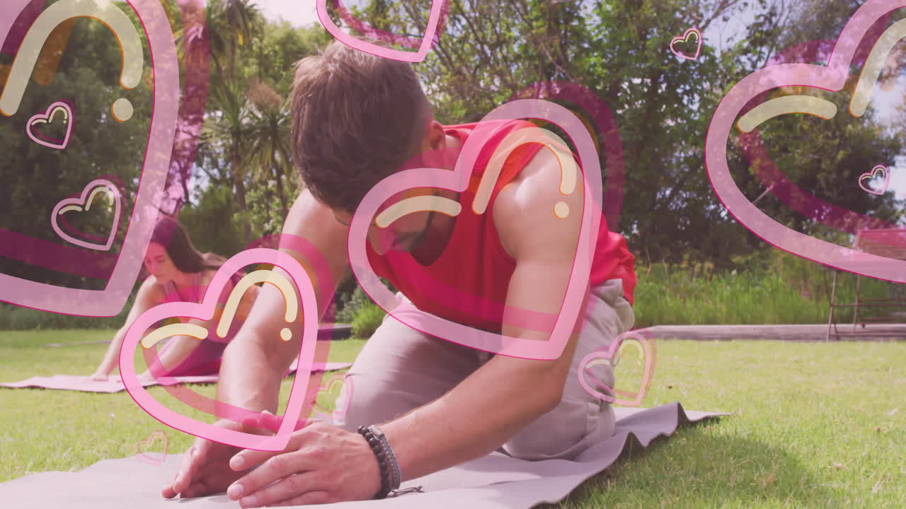 Man stretching on yoga mat with heart animations overlaying scene