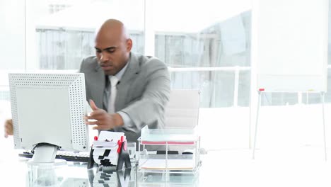 Depressed-businessman-working-at-a-computer