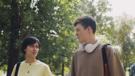 College-Students-Walking-in-Park-and-Speaking