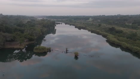 Drohne-Sinkt-In-Richtung-Des-Komati-Flusses-Am-Frühen-Morgen,-Buschland-Savanne-Umgibt-Den-Fluss