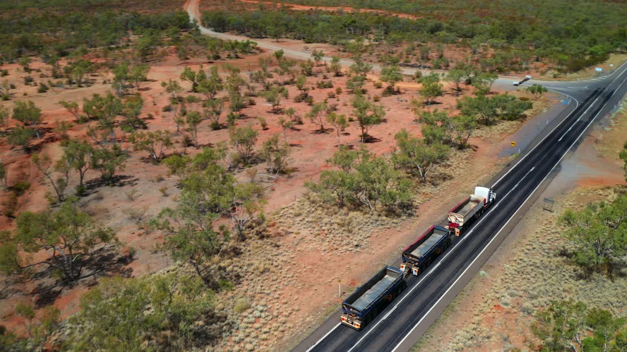 Trucks Driving Through Narrow Road  - aerial shot