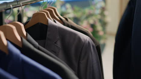 man browses clothes racks in thrift shop