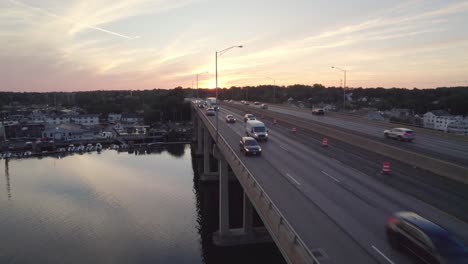 forward rising drone shot of interstate with cars at sunset