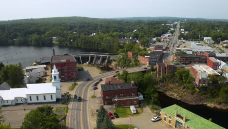 Aerial footage of Skowhegan, Maine downtown with Kennebec River and Dam in foreground