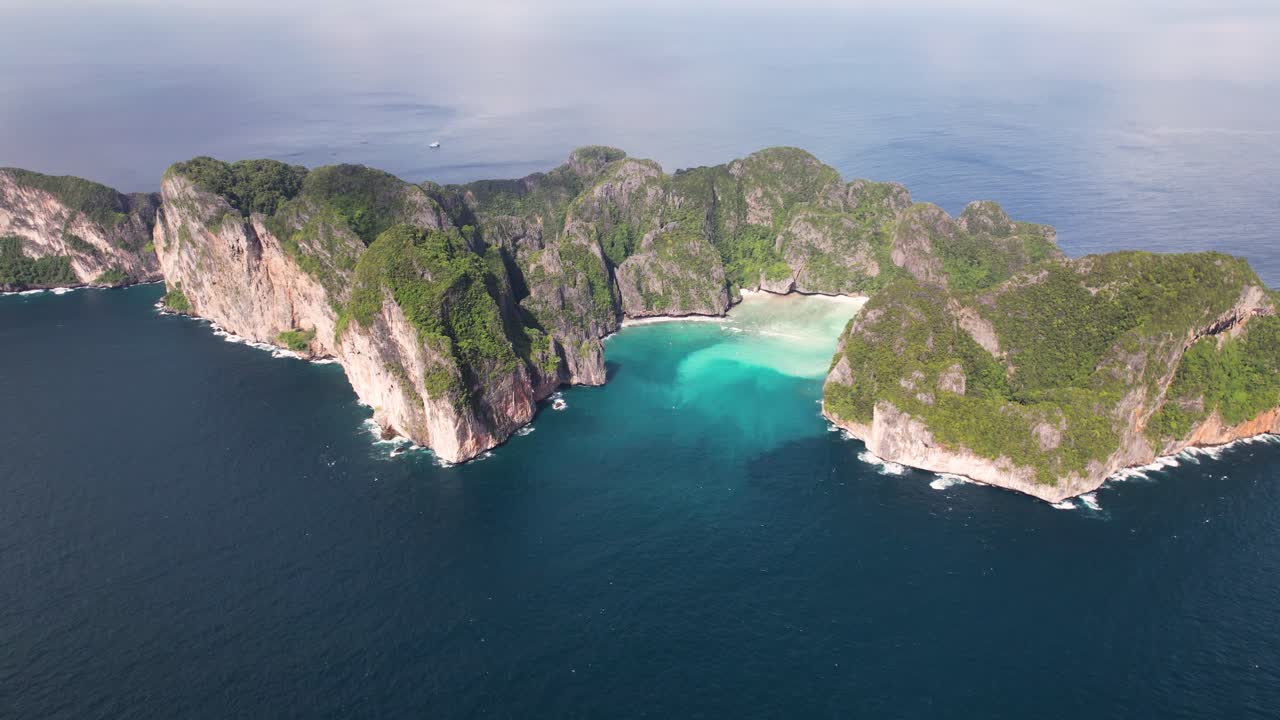 Aerial drone video of Phi Phi Leh with Maya Bay and Pileh Lagoon, Krabi province, Thailand. Aerial top view of amazing tropical island with turquoise water and white beach, famous travel destination.