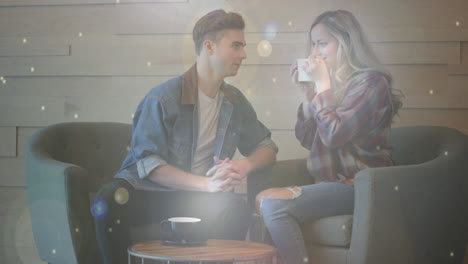 glowing spots of light against couple talking while having coffee