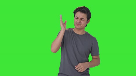 Indian-man-smelling-disgusted-object-Green-screen