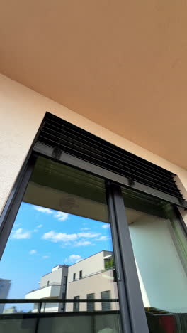 chic balcony with stylish shutters. a contemporary balcony showcasing sleek vertical window shutters reflecting the clear blue sky above
