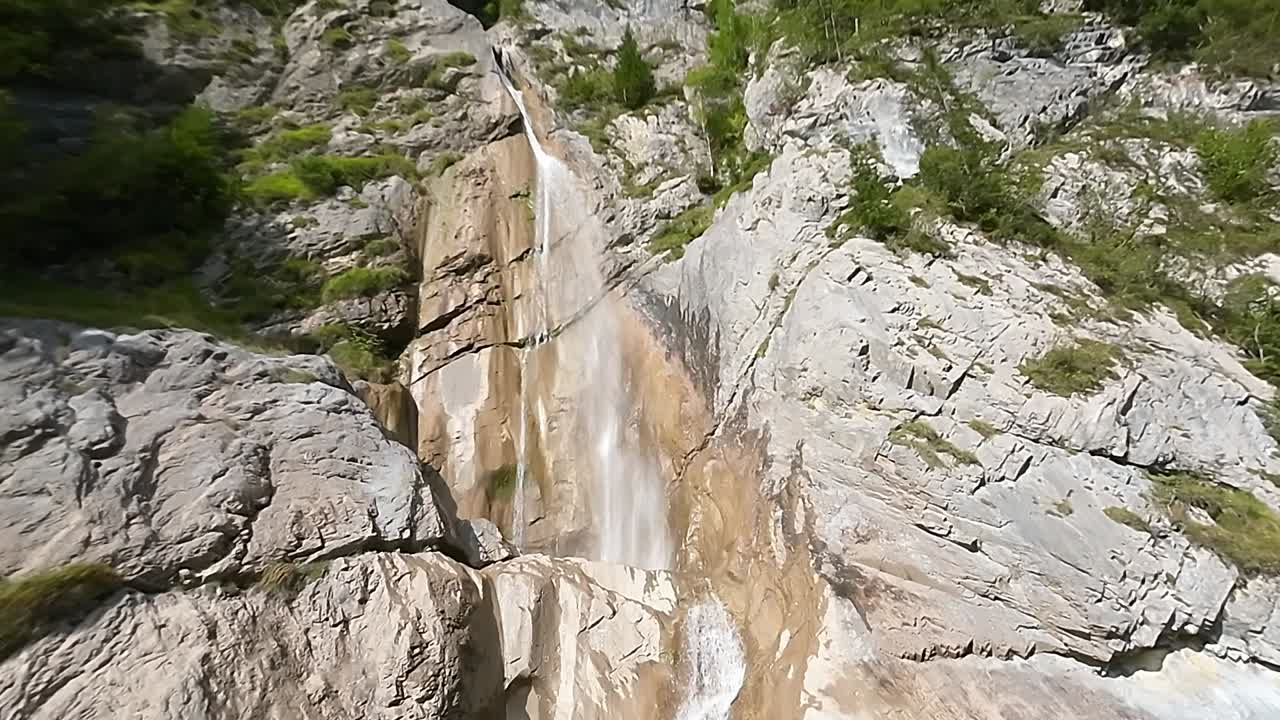 ascender aéreo cerca de la montaña con cascada, ritmo rápido regreso a la pradera verde
