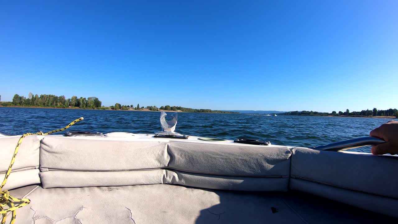 Boat trip on columbia and willamette portland rivers. Oregon, US. Blue sky and water. Pulling a big tire.