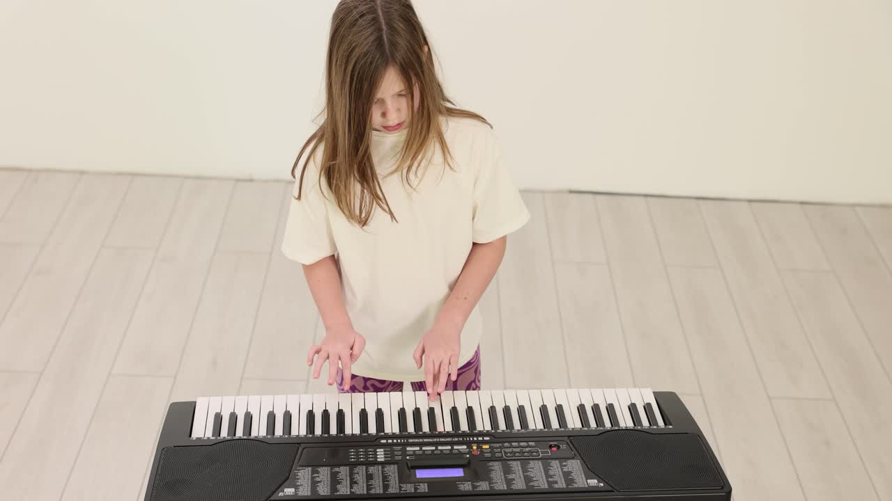 Girl playing electronic keyboard