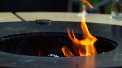 Flame-burning-out-from-grill.-Fire-burning-in-slow-motion-on-backyard