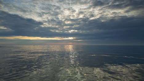 Slow-motion-flying-very-low-over-gentle-waves-at-sunset-on-Fleetwood-Beach-Lancashire-UK