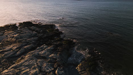 Aerial-dolly-above-Brenton-Point-Newport-Rhode-Island-at-Sunrise-on-rocks-and-ocean