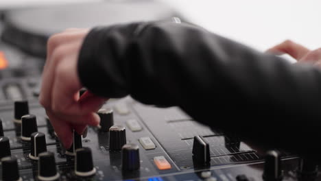 dj mixing music on a soundboard