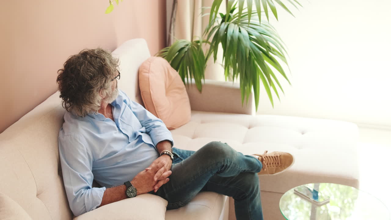 Mature Man Relaxing on Sofa in Modern Living Room