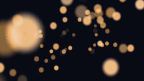 animation of glowing orange spots of light moving in hypnotic motion on black background