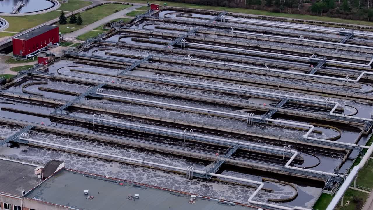 Side gliding drone footage over structured sewage flow system in Riga facility