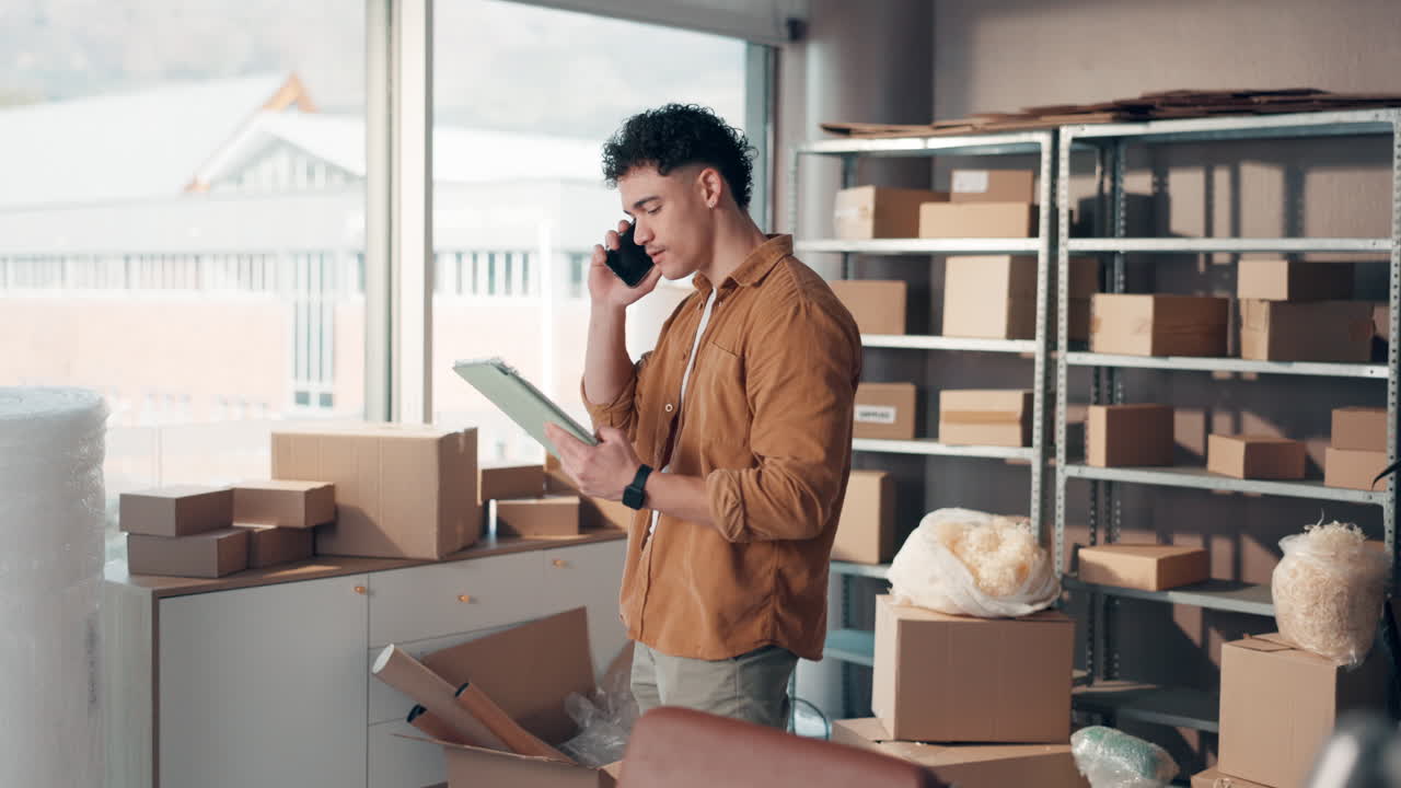 Man on Phone Surrounded by Shipping Boxes in Warehouse