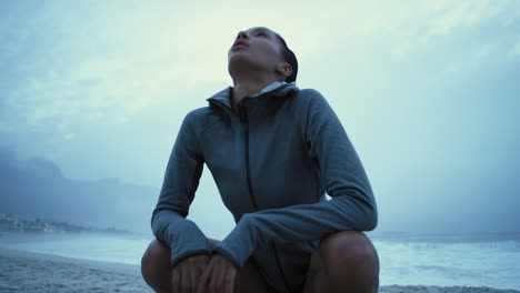 runner, fitness and breathe with woman on beach