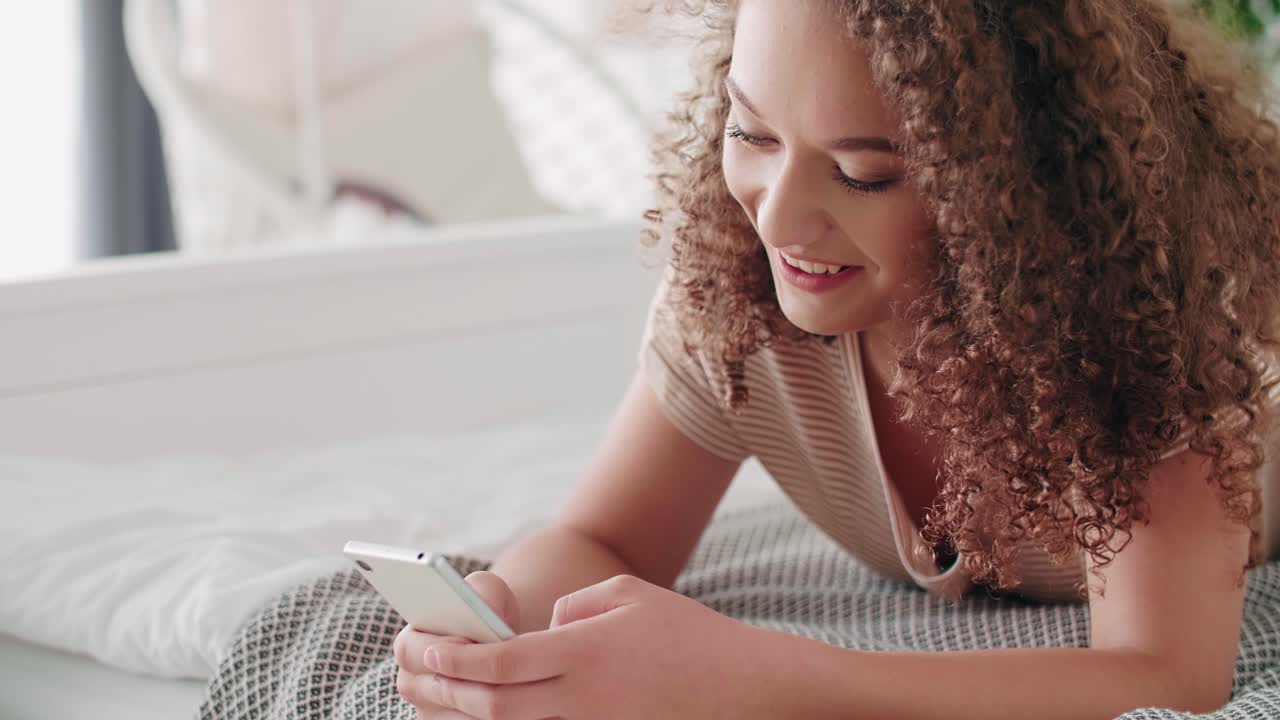 Happy teenage girl using a mobile phone