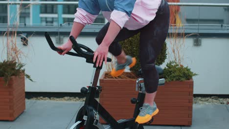 woman performs aerobic endurance training workout cardio routine on the simulators, cycle training