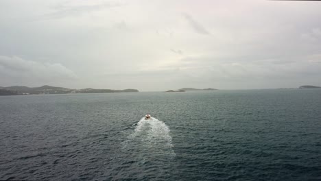 Aerial-Drone-4k-video-following-a-small-ferry-our-from-Mlini-Harbour-heading-out-towards-islands-off-there-coast,-Croatia