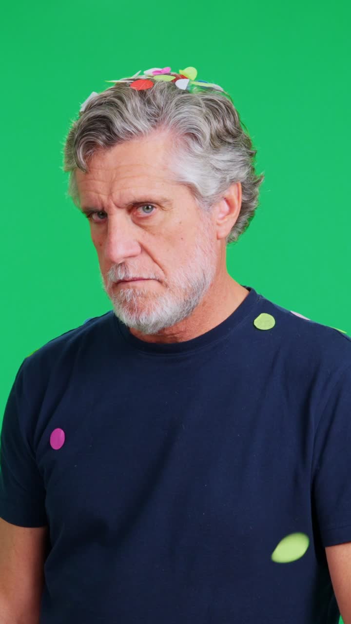 Serious Man Covered in Falling Confetti on Green Screen