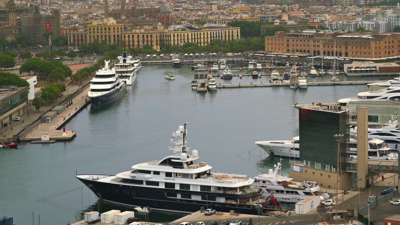 Barcelona, Spain - June 22, 2021: Aerial drone view of boats docked in the Port Vell