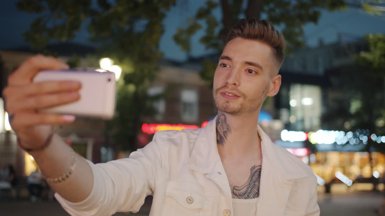 Man Taking a Selfie at Night in the City