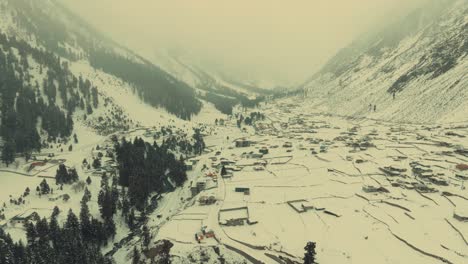 Famous-Naltar-Valley-covered-in-snow-captured-by-drone-during-morning-in-Gilgit,-Pakistan