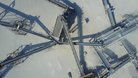 outdoor stone crushing construction machinery from above, aerial shot