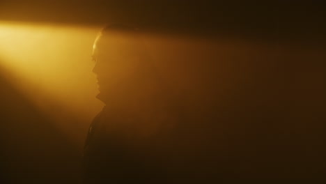 woman in a smoky studio setting
