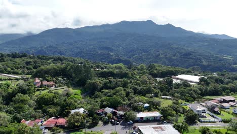 aerial drone video of a small town in front of a mountain in central america