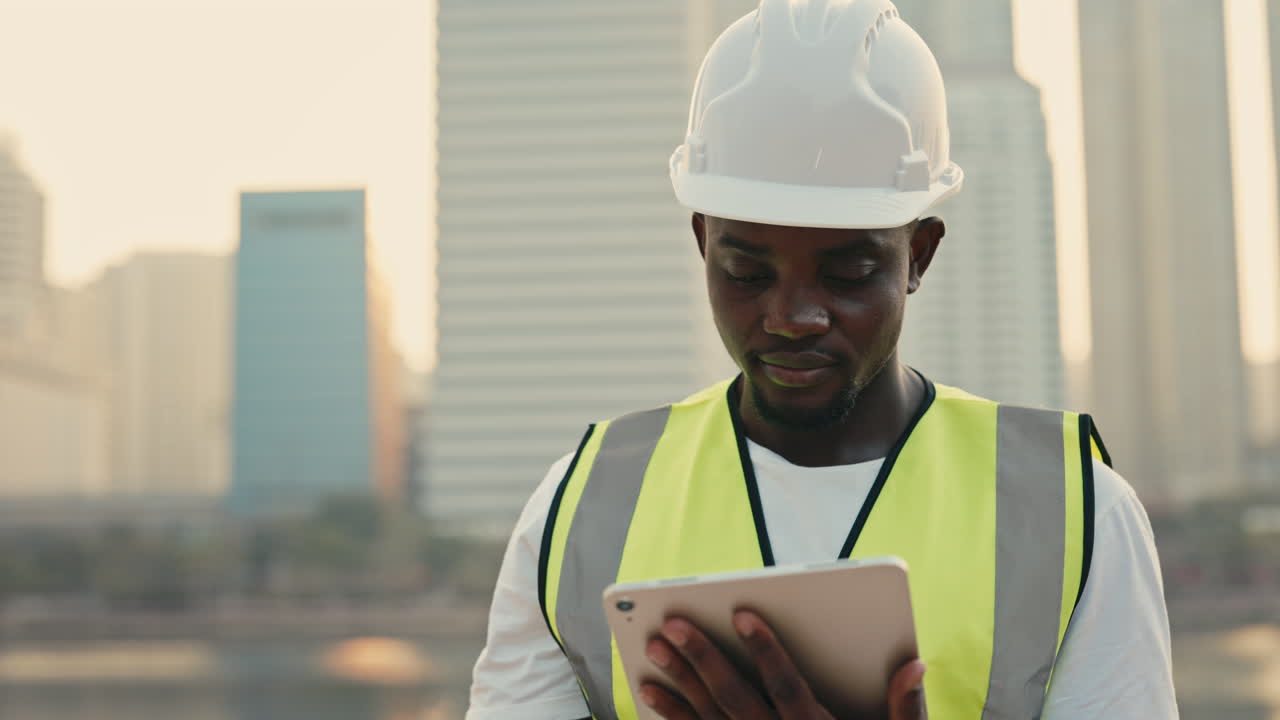 Construction worker using tablet in city