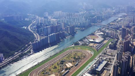 Beautiful-circular-Shatin-race-track-between-the-high-skyscrapers-next-to-the-Shing-Mun-River-on-a-sunny-day