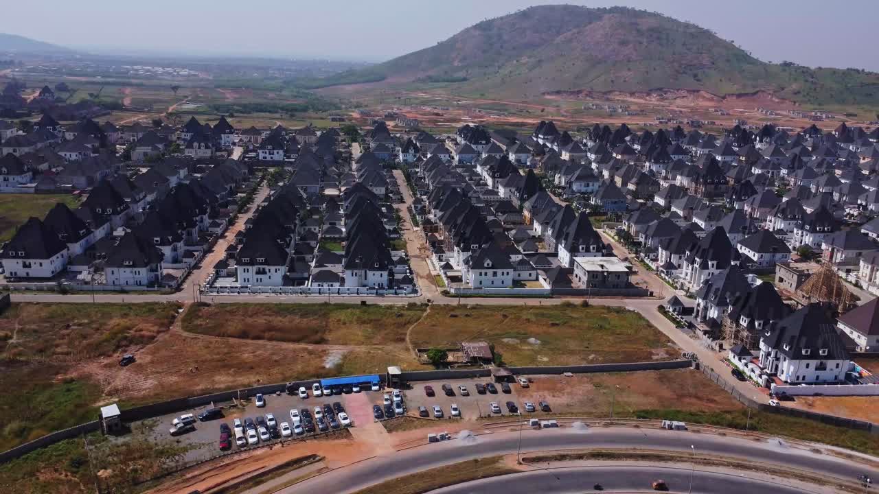 High angle view of a large and wealthy suburban neighborhood with a beautiful mountainous landscape in the background in Abuja, Nigeria
