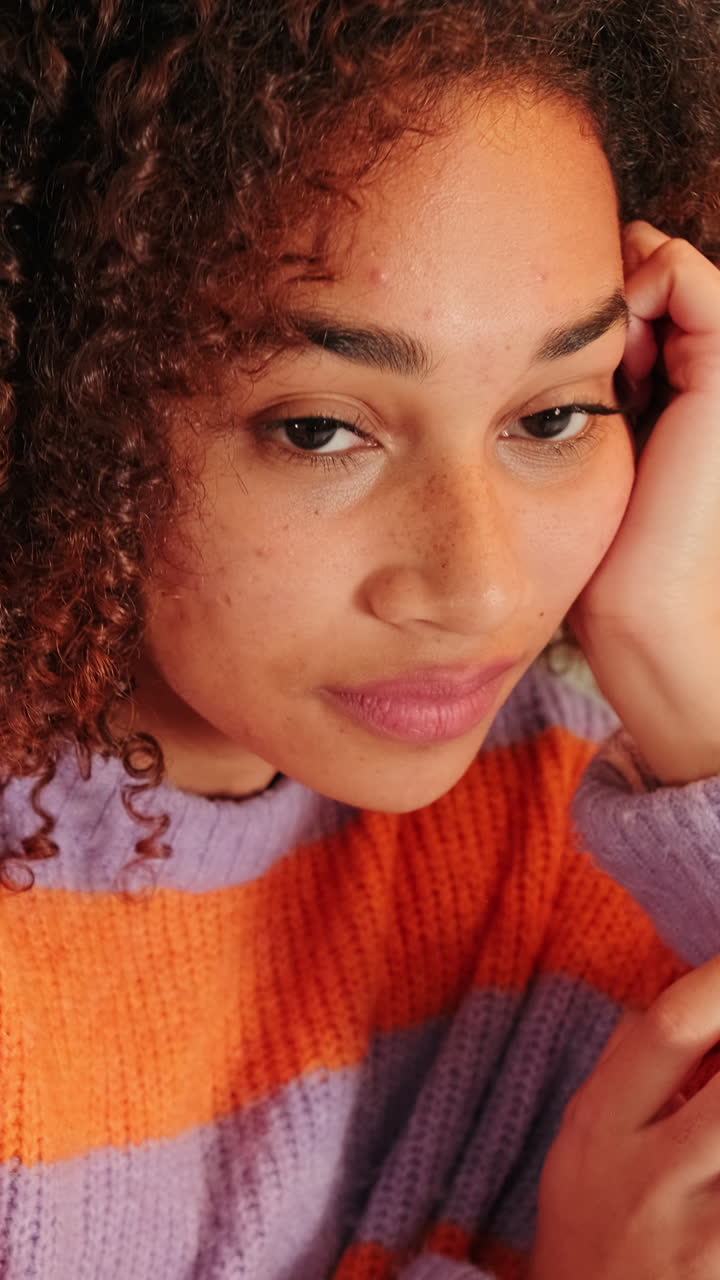 Close-up Portrait of Young Woman with Curly Hair and Freckles